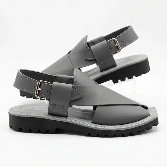 A pair of dark gray leather slingback sandals with chunky black lug soles, displayed on a clean white background.