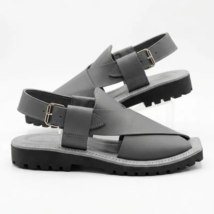 A pair of dark gray leather slingback sandals with chunky black lug soles, displayed on a clean white background.