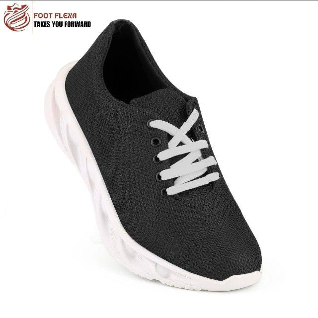 Black athletic shoe with white laces on a white background, featuring the Foot Flexa brand.